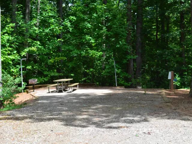 Gravel site with fire pit, grill, table