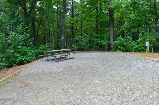 Gravel site with fire pit, grill, table