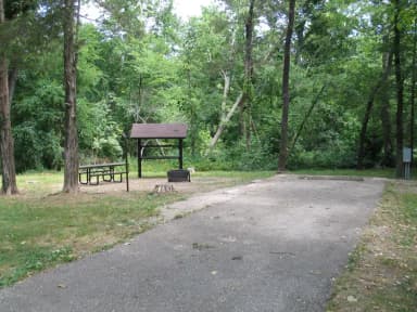 Campsite 11 showing parking spur, picnic table, lantern post, food shelter, fire ring and electric hookup.