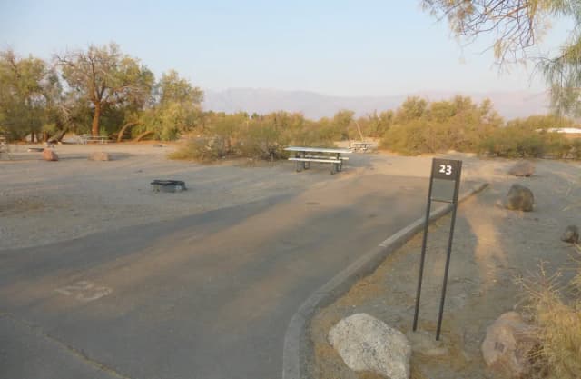 Furnace Creek Campground standard nonelectric site #23 with picnic table and fire ring.