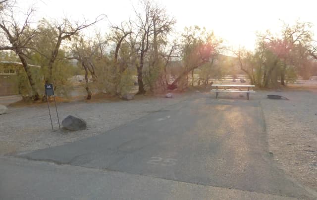 Furnace Creek Campground standard nonelectric site #25 with picnic table and fire ring.