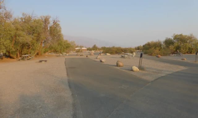 Furnace Creek Campground standard nonelectric site #26 with picnic table and fire ring.