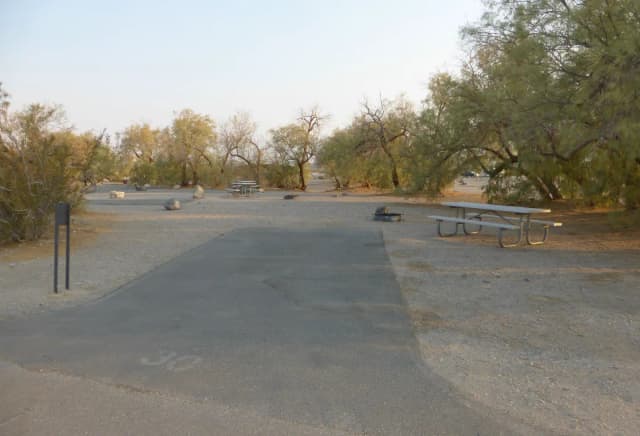 Furnace Creek Campground standard nonelectric site #30 with picnic table and fire ring.