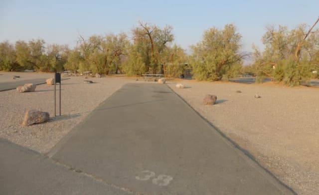 Furnace Creek Campground standard nonelectric site #38 with picnic table and fire ring.