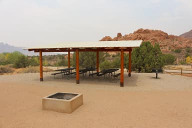 Ken's Lake Group Site B shade shelter, picnic tables, standing grill, and fire pit area.
