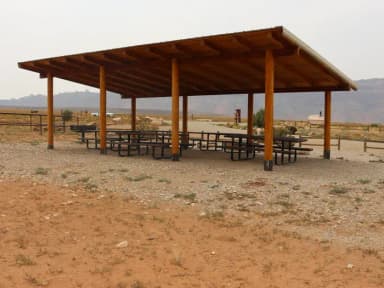 Ken's Lake Group Site A shade shelter with picnic tables underneath.