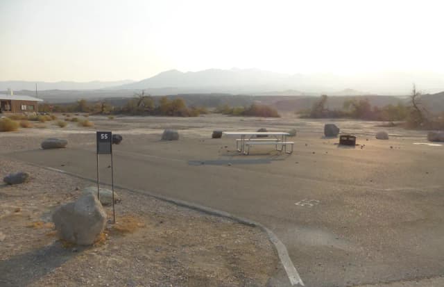 Furnace Creek Campground standard nonelectric site #55 with picnic table and shared fire ring with site #54.