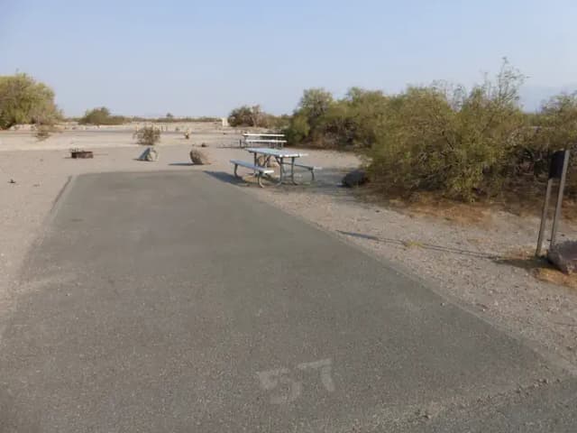 Furnace Creek Campground standard nonelectric site #57 with picnic table and fire ring.