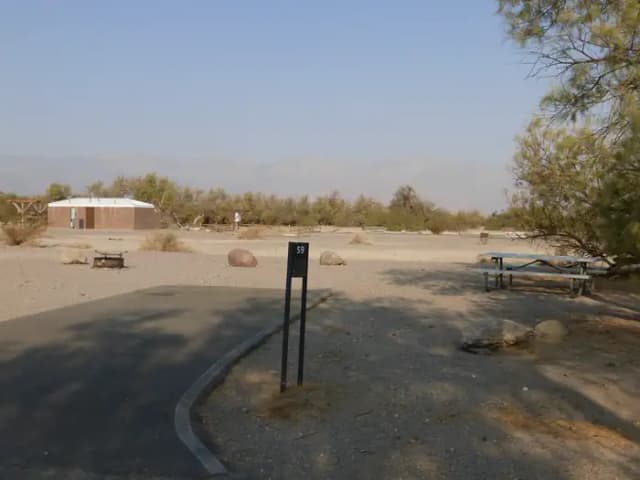 Furnace Creek Campground standard nonelectric site #59 with picnic table and fire ring.