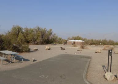 Furnace Creek Campground standard nonelectric site #61 with picnic table and fire ring.