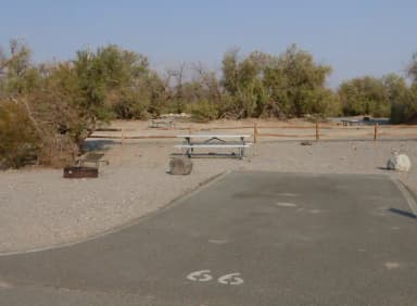 Furnace Creek Campground standard nonelectric site #66 with picnic table and fire ring.
