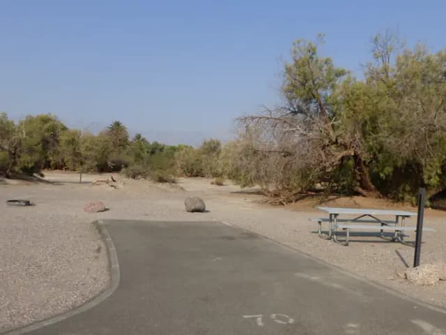 Furnace Creek Campground standard nonelectric site #70 with picnic table and fire ring.