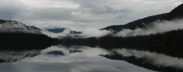 View of lake and mountains from Virginia Lake Cabin with misty clouds over lake