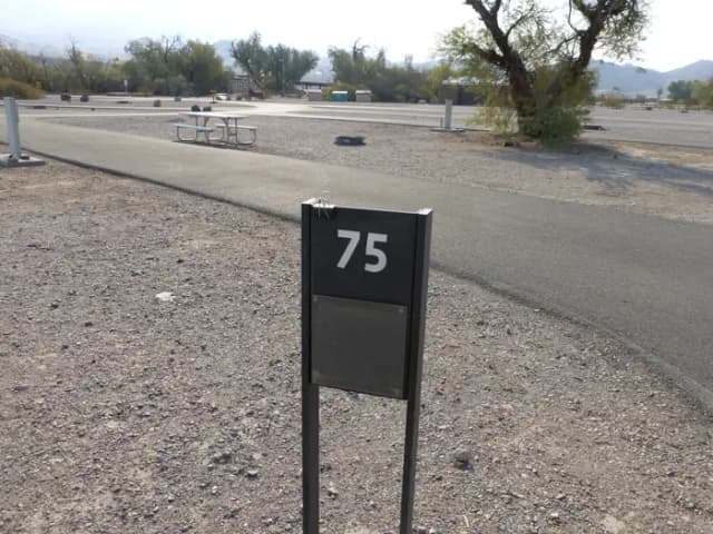 Furnace Creek Campground full hookup site #75. Water, sewer, and 30/50 amp electric connection. One fire pit and one picnic table.