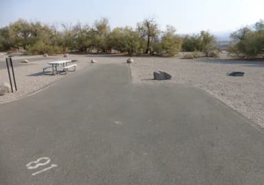 Furnace Creek Campground standard nonelectric site #81 with picnic table and fire ring.