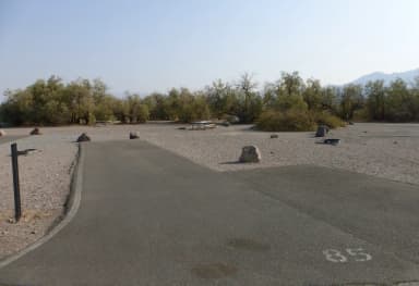 Furnace Creek Campground standard nonelectric site #85 with picnic table and fire ring.