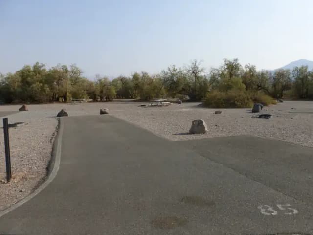 Furnace Creek Campground standard nonelectric site #85 with picnic table and fire ring.