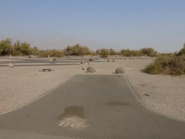 Furnace Creek Campground standard nonelectric site #86 with picnic table and fire ring.