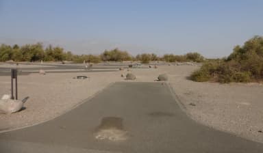 Furnace Creek Campground standard nonelectric site #86 with picnic table and fire ring.