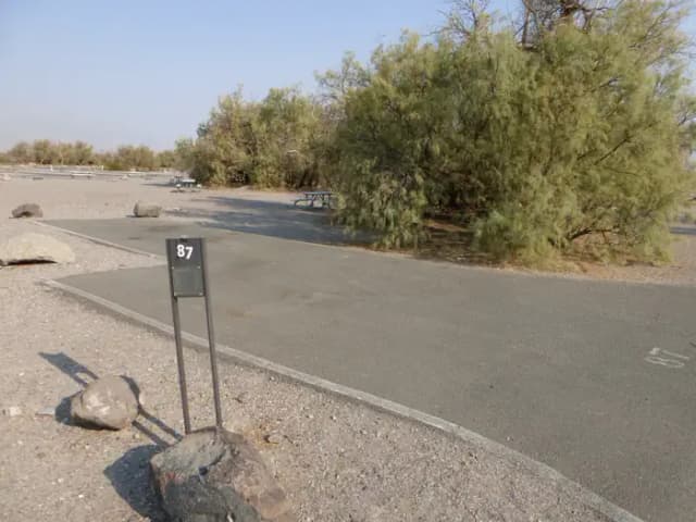 Furnace Creek Campground standard nonelectric site #87 with picnic table and fire ring.