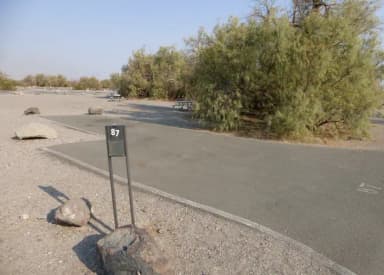 Furnace Creek Campground standard nonelectric site #87 with picnic table and fire ring.