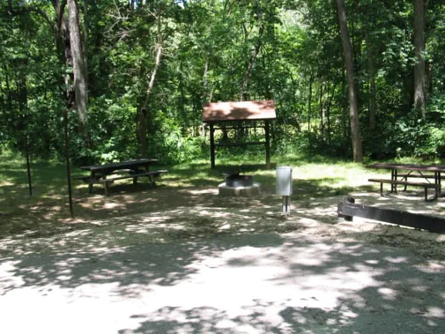 Campsite 27 showing parking spur, picnic tables, lantern posts, food shelter, electric hookup and fire ring