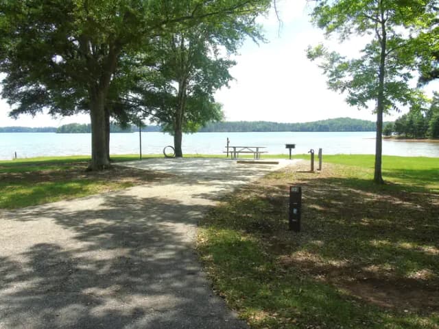 Campsite with Picnic Table, fire ring, and grill.