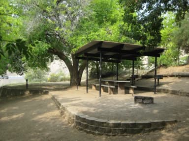 Camp site with shade shelter and fire grill.