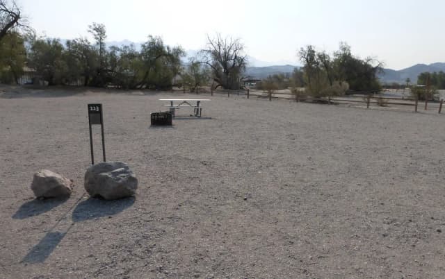 Furnace Creek Campground standard nonelectric site #113 with picnic table and fire ring.