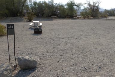 Furnace Creek Campground standard nonelectric site #114 with picnic table and fire ring.