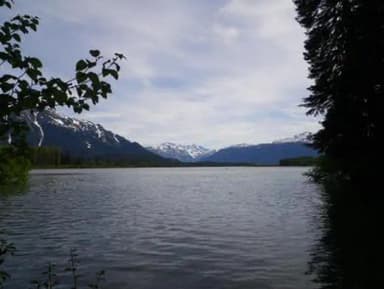 Mount Flemer Cabin scenery with water and snowcapped mountains