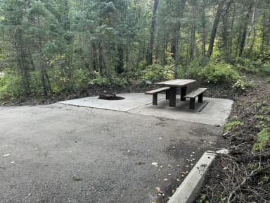 Picnic table and fire ring from parking spur, filed by the agency against 2 campsites at Tinney Flat